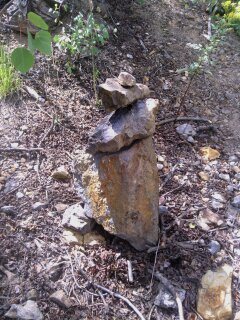 The cairn, take a left directly towards the wall. 30 seconds to go.