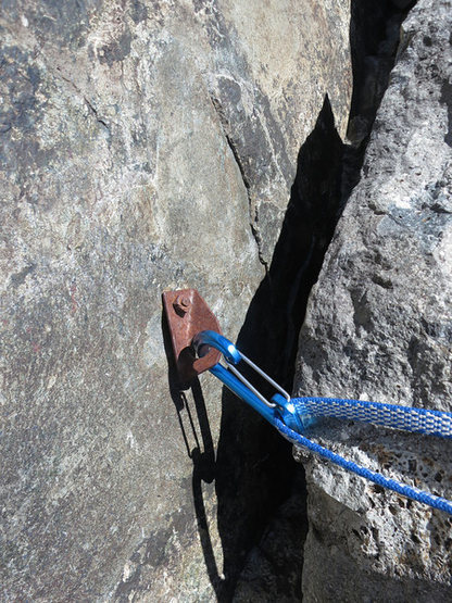 Really old rusted hanger at the top of the 5th. At a nice ledge before the traverse pitch. The first dihedral follows.