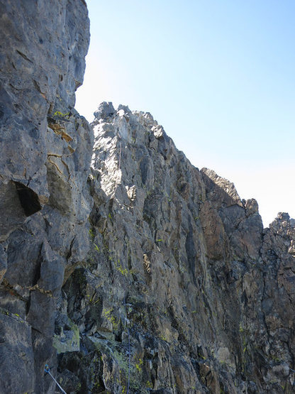 Once you reach the top you climb around the right of the summit pinnacles. It's still another couple/three pitches of scrambling from here and easily soloed or simul'd.