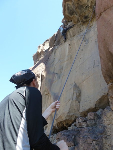 Luis trying to find a reasonable way to the top of the rimrock on Heart Throb.