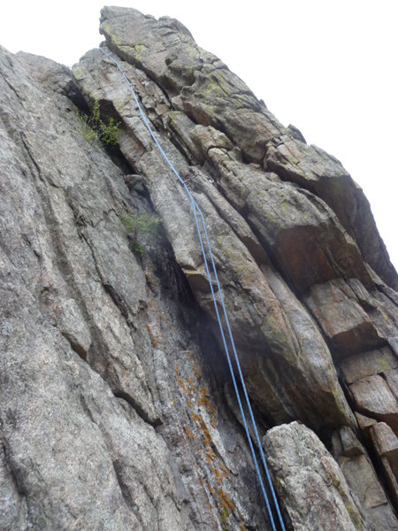 The crack is to the right of the rope.