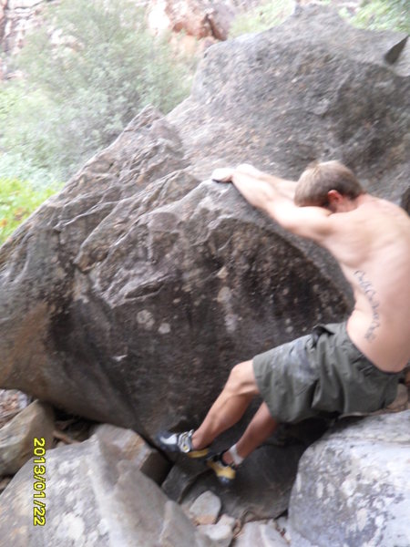 The start on the jug, next move is for the lip after finding feet..this is right after coming out from underneath the large boulder.