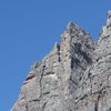 Photo shows upper pitch details, which are on the face just R. from arête crest.