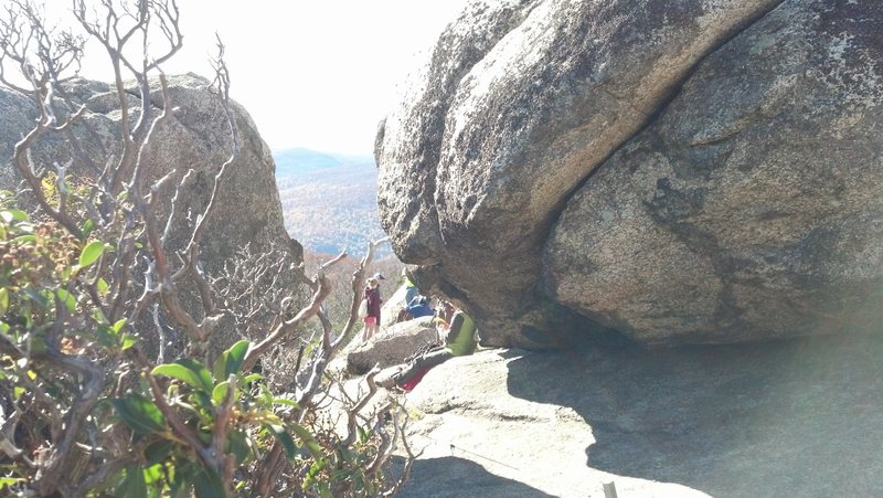 At the summit, head between these boulders . One will be marked with a diagonal crack. Now you're on track to reach Beginner's Crack and Summit Crag.