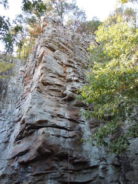 Base of climb with rope hanging from top anchor. Many of the bolts are off to the side of line.