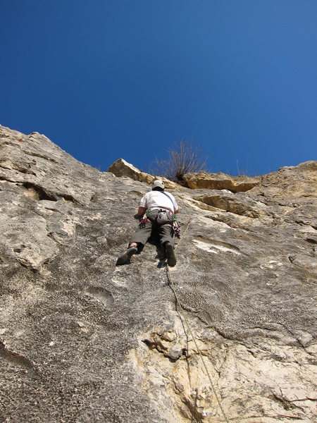 Standing in the horizontal slot shortly after making the crux moves and clipping the second bolt.