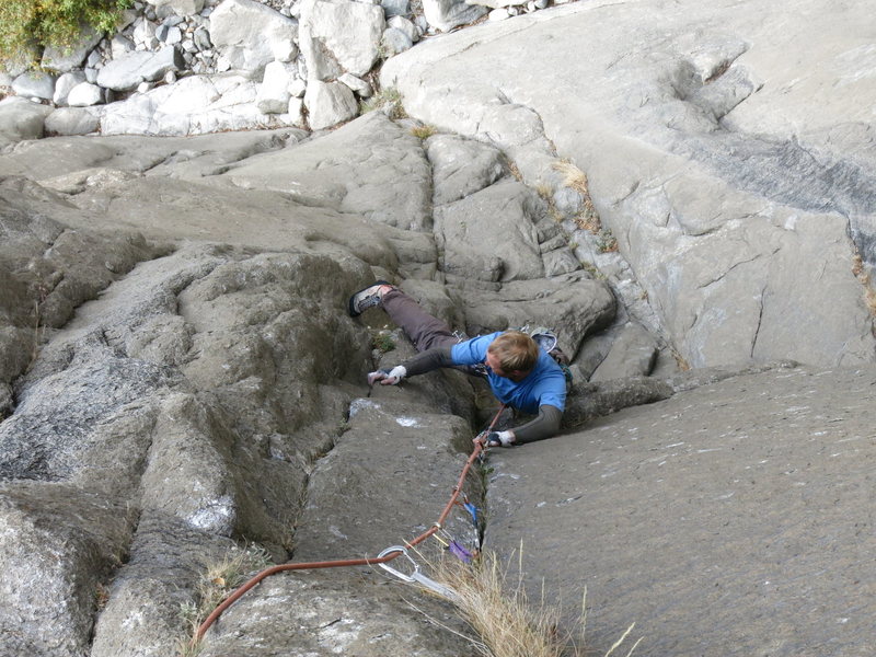 Starting the 5.11 finger section past the crux on pitch one.