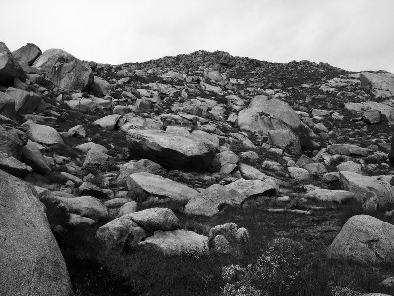 Mystic cirque as seen from the approach just past Roadside boulder. Bachar Cracker of Bernasconi is on the west side of giant Saucer shaped boulder in photos center.