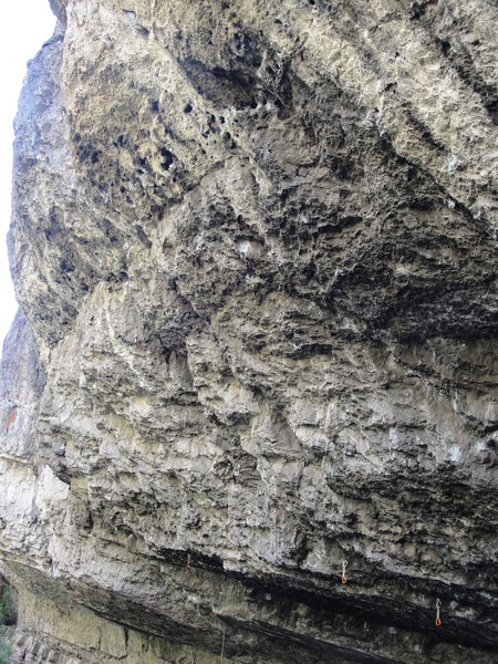 Top half of Trench Warfare- 13c. Follows a left-trending flake/crack system into a faint dihedral below the chains.