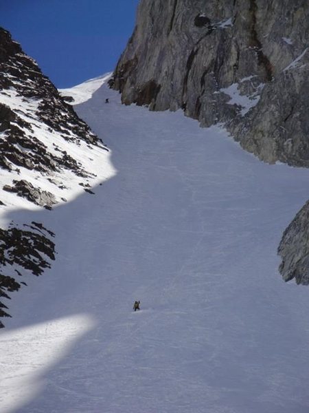 Kindergarten Gully. A snowboarder and skier enjoying a spring descent.