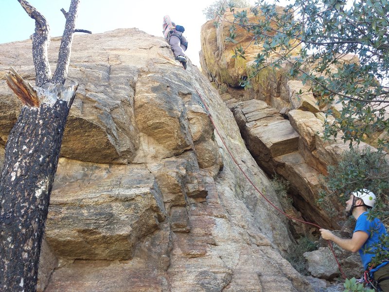 Anna clipping the second bolt. Climb starts directly below the slight bulge on the corner and climbs up and over this feature.