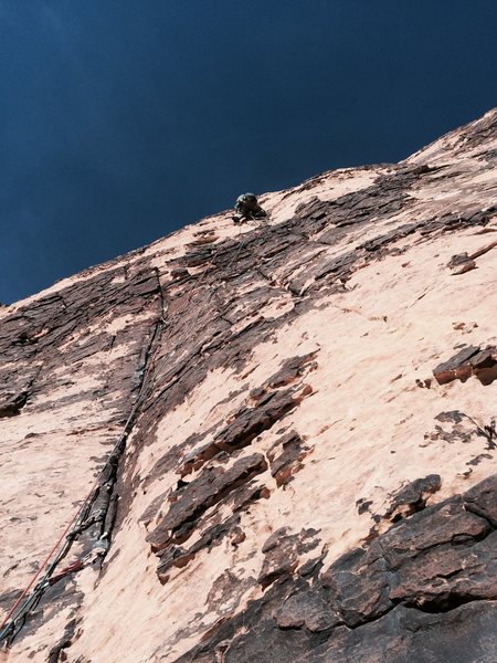 J. Connell Leading Pitch 2, just beyond the initial finger crack and the right traverse to gain the next line.