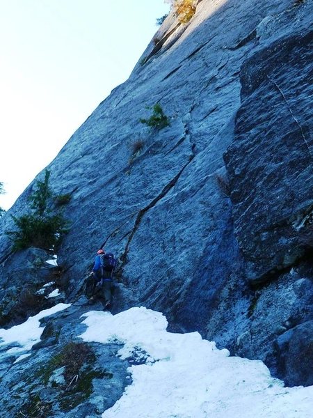 The Rash route heads up the right-facing flake above the climber. Belay on the sloping ramp with gear - it's not usually snowy