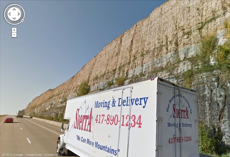 Google streetview showing the road cut during the warm season. Also in the picture is a freight company truck delivering mountains to Wisconsin.