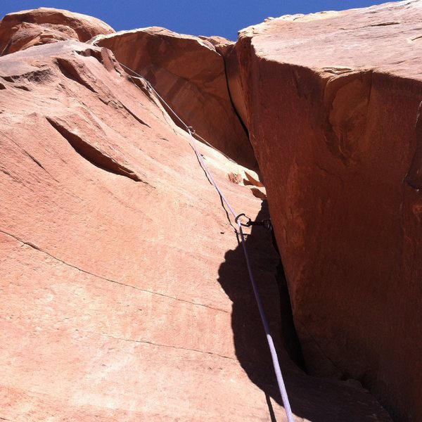 Looking up pitch 4. Traverse left under the roof to the crux bulge pull on fingers.