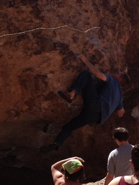Finishing the crux on No One Here Gets Out Alive, Hueco Tanks. Heel hook on the lip and pull left/up. Awesome climb!