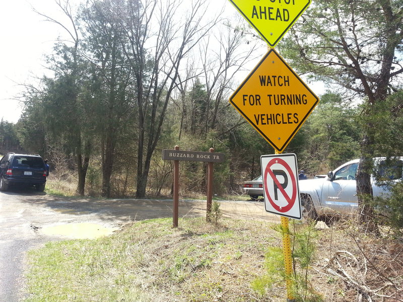 View of entrance to trailhead parking lot as you head south on Mountain Rd.