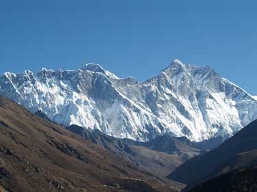 Mt. Everests summit looms above Nuptses long ridgeline, and Lhotse is to the right. <br>
by Dougald MacDonald.<br>