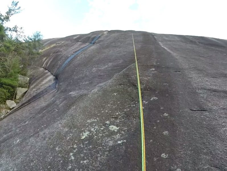 P1 - The anchors that mark the start of the 5th class climbing are not quite visible in the pic, but are just to the left of the rope a few feet higher than the level from where the pic was taken