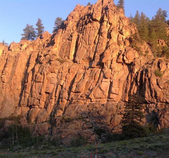 Early morning light on the upper wall of Harmel's.<br>
Routes visable from Aphrodite on the left through Christine's Dream in the middle and on past Kathy's Corner on the right. Maria's Farewell starts right above the end of the big pine tree's shadow.<br>