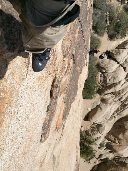 Right below the 2nd bolt looking down.