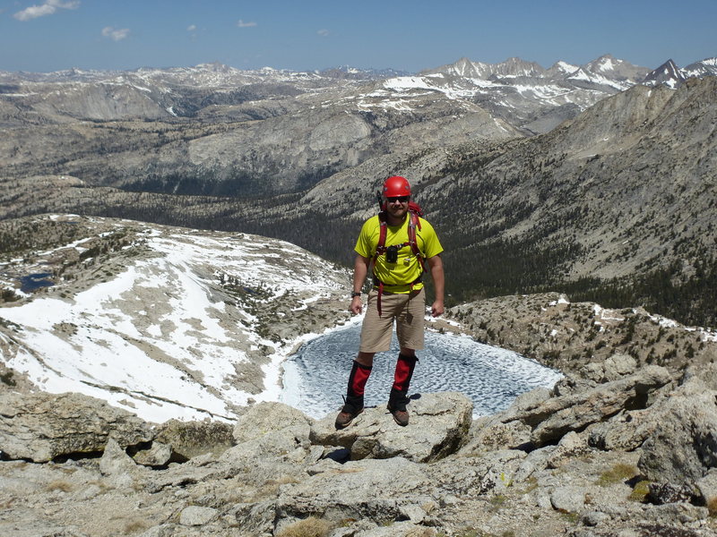 Barry on NW Ridge, looking northwest with Upper McCabe Lake below. Tower Peak is left of center; Whorl Mtn (South, Middle, and North), Matterhorn Peak, Virginia Peak are off to right.