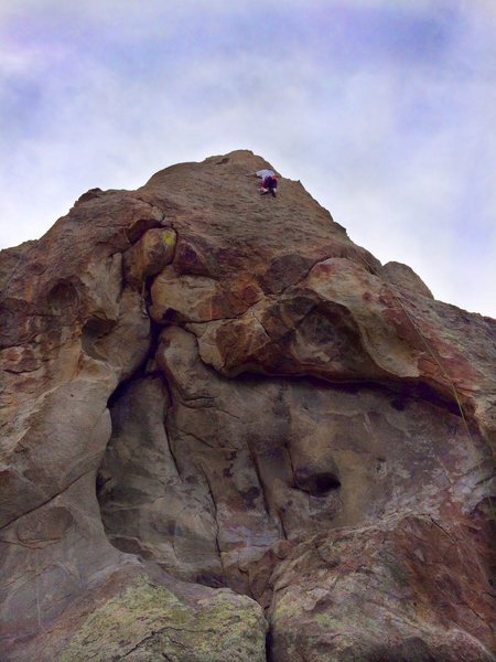 The lowest bolt shown in the white rock - lower left - is clipped while hanging onto some rat dropping holds. Could use a cam to help not hit the ground.