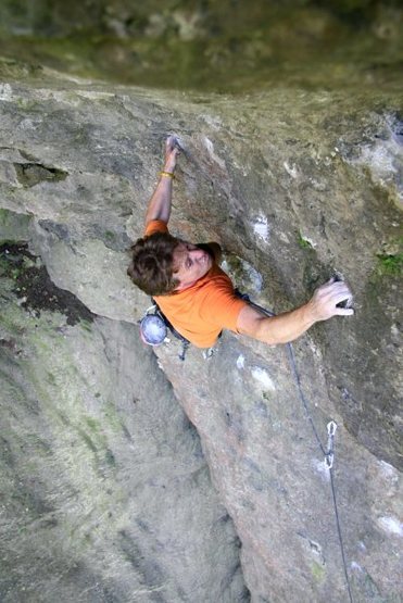 Markus Maier at the top making the big span move to the last pocket before the jugs at the end. Photo from https://www.frankenjura.com/klettern/poi/6048