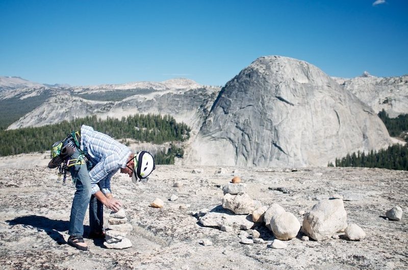 Greg adds to the cairn collection on the summit of Daff, with Fairview in the background.
