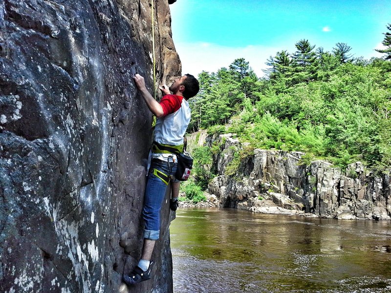 Taylor's first day of outdoor climbing in MN; halfway up Iron Ring aka Witches Tit on Angle Rock on a perfect July day.