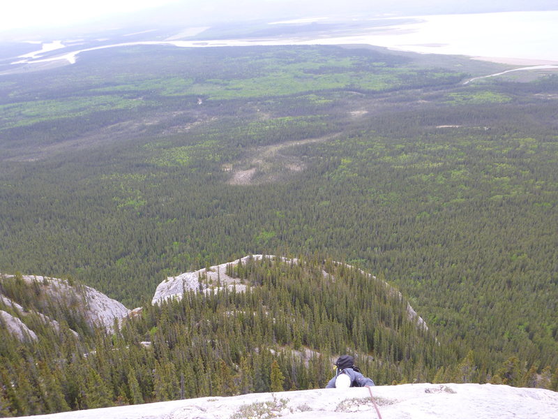 Marcin climbing over the last lip on the last pitch.