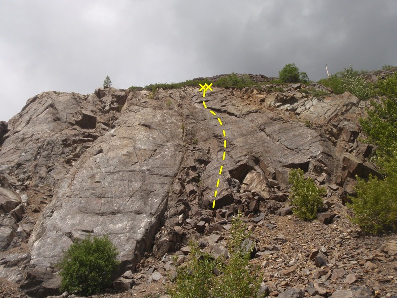 Progression climbs directly under the anchor on the upper cliff.