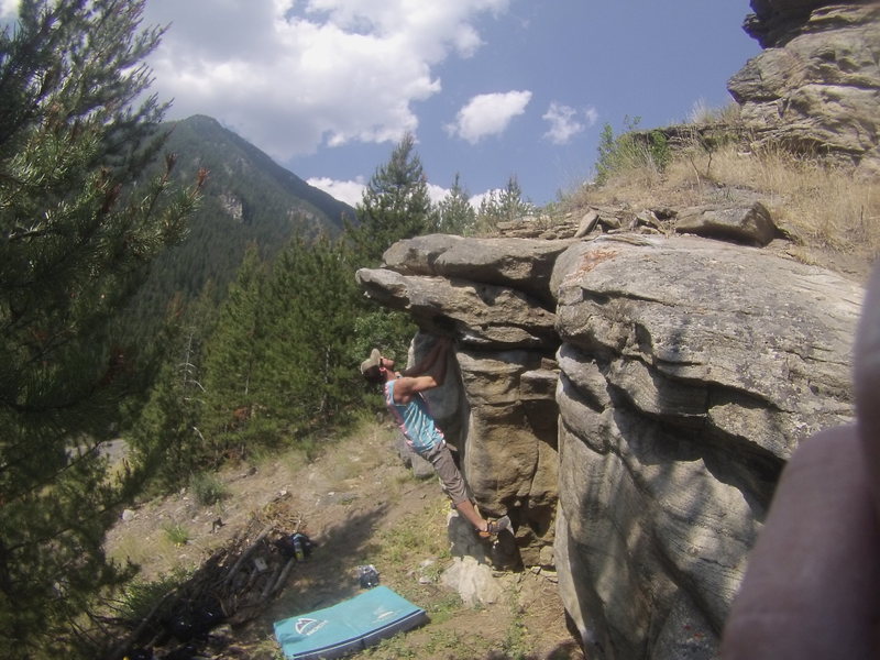 Using only the first holds on the rail. Shoot up to the far roof.