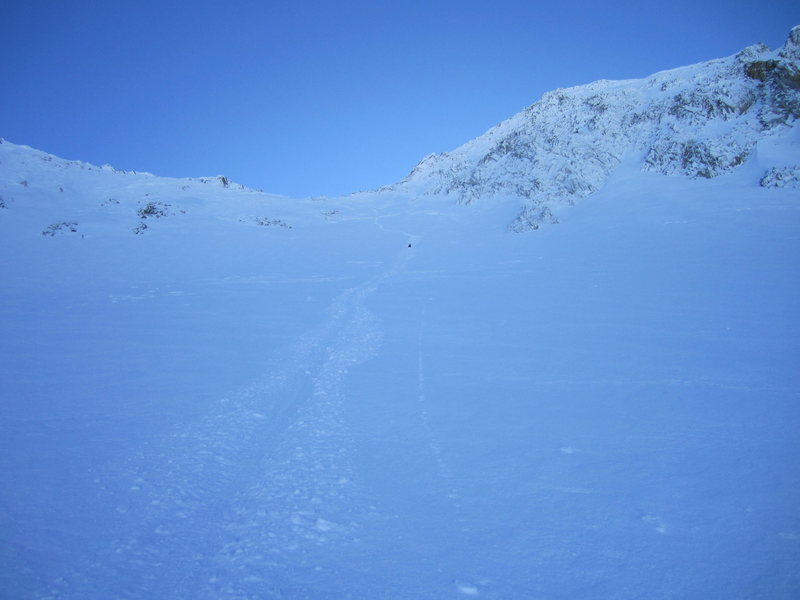 An avalanche-aware traveler of the back-country, Tyson evaluated the North-East snow-field of the mountain, which runs from the base almost to the top, as safe to walk down. Confident outward-facing plunge-stepping was mixed with inward-facing down-climbing until we arrived at a point where glissading was a reasonable and exciting option.