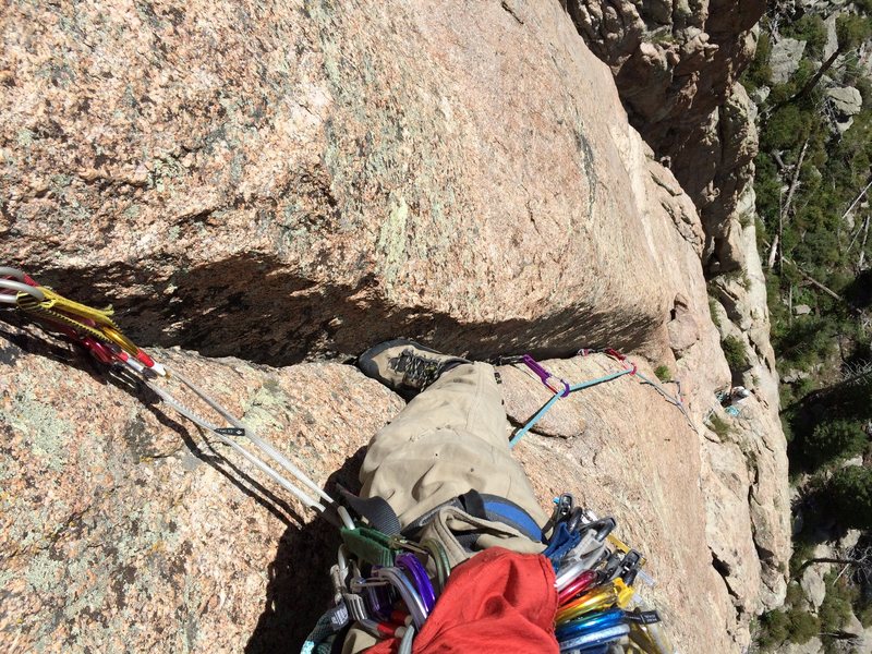 Recommended variation on P2 (as described here) is to layback the first stuff as usual but then head up and slightly right to the bottom of this splitter crack. 5.9 on the Rossiter topo, but it goes easy for Lumpy 9. As it fades, traverse straight left (5.8 face) to the bolts.