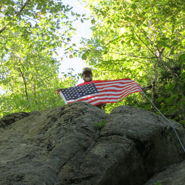 First ascensionist Todd Paris flying the colors atop A Peney For Your Freedom. The flag will proudly fly at my home in Massachusetts.