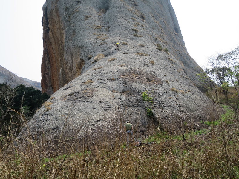 First pitch. Drilling the first bolt on the FA. The route follows the rib directly above the leader.