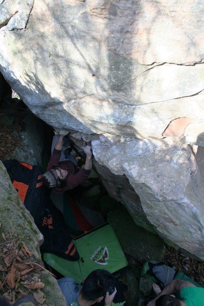 Boris on V2ish problem. Don't know what this is called or how to describe getting there. Uphill and right of Warmup Wall. Sit start and traverse up and right, eventually around arete for top out. Needs several pads or spotter to move single pad (or, just don't fall). Very fun problem in a very weird spot. Stays wet longer than most other problems due to location. Do not climb wet rock here.