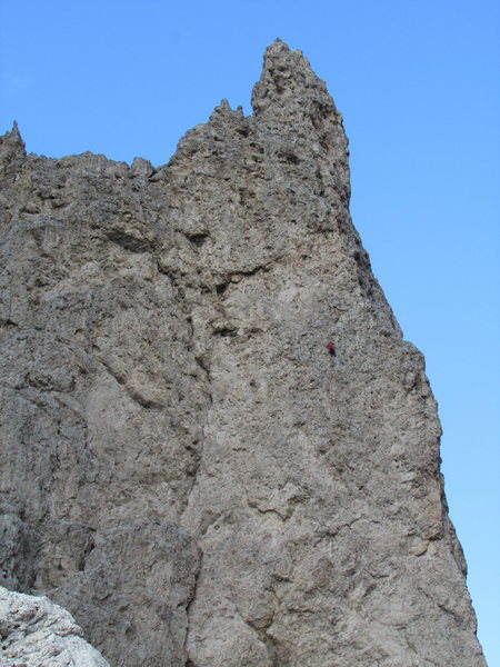A red-clad climber on the Langkofelscharte face of Dito di Dio.