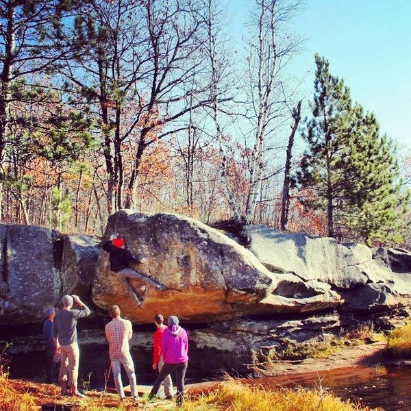 Climber on Best V5 (V5) on the River Boulder. Invisible Touch (V8