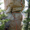 The lower slab portion of the North Face route may have a 5.10 move. The upper overhanging crack is more like 5.9 moves.