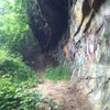 Large overhanging wall at the base of the trail leading down to the brook