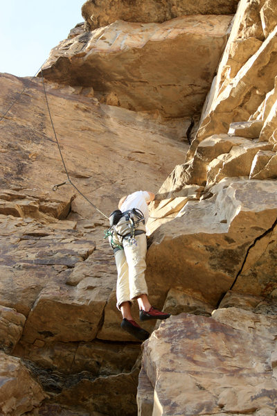 Mike Santoro pulling the small roof to gain the ledge.