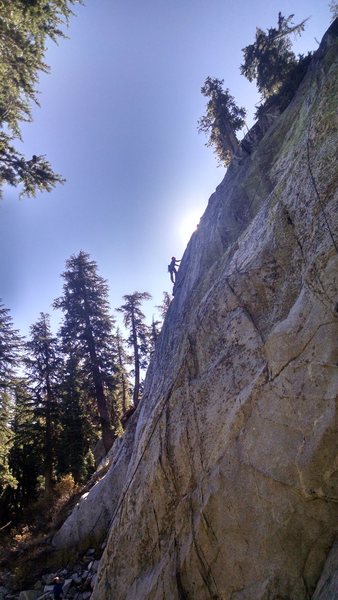 Justin Colville reaching up on the exposed arete on the second ascent