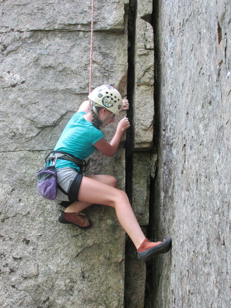 Alexa Chalnick 12 years old on Stone Cutters Bible 5.7 Canada Cliffs Acadia National Park. The parallel rope and cracks contrast well with Alexa's form in this layback move. This is one of my favorite photos. This photo is also on page 4 of the 2016 Spring addition of Friends Of Acadia Magazine.