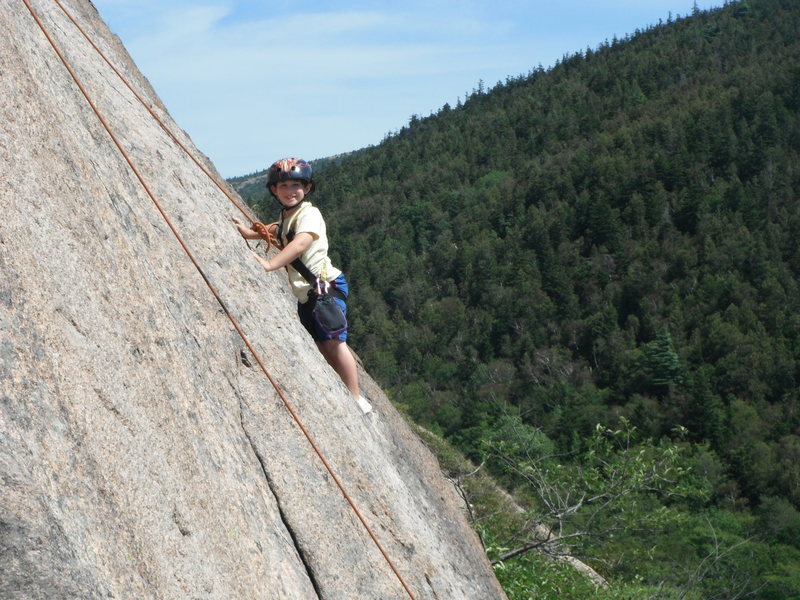 Jonah Chalnick climbing the upper slab on South Bubble Mountain in Acadia National Park