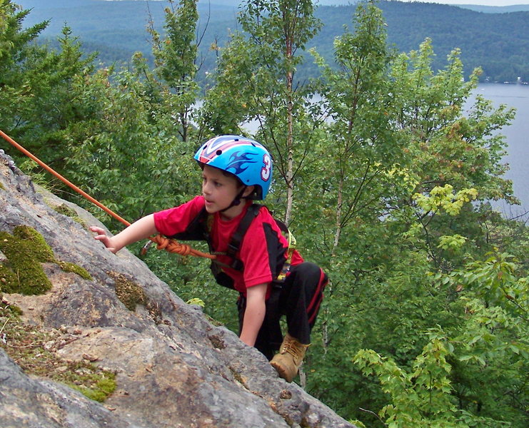 ZACHARY CHALNICK AT 5 YEARS OLD CLIMBING SUMMIT SLABS ON ROCKY MOUNTAIN NEAR OLD FORGE NY. FORTH LAKE OF THE FULTON CHAIN IS IN THE BACK-ROUND.