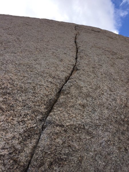 Not very long, but a really fun finger crack. Certainly worth the 10 min walk to this area to run up.