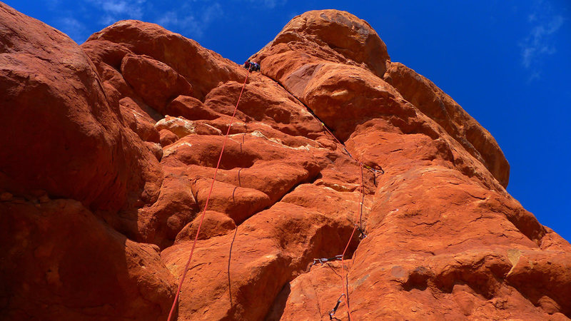 Steep 5.10 hand crack leads to bolt ladder.