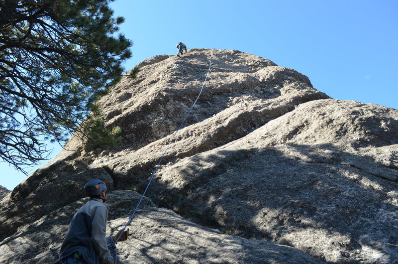 The route runs slightly left of where the rope is hanging.